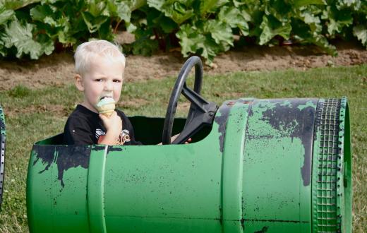 Young boy enjoying an ice cream cone at a playground in Lynden, Washington