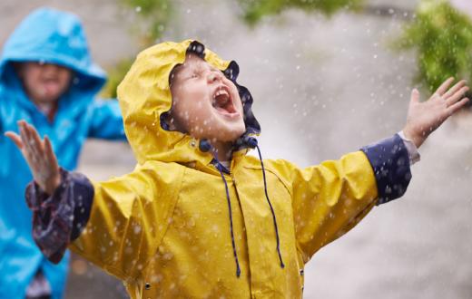 Boy shouting into the rain