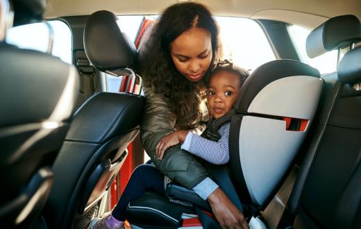 mom unbuckling daughters car seat