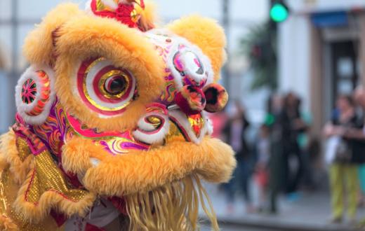 Close-up of yellow lion head during traditional Chinese lion dance lunar new year celebrations Seattle families 2021