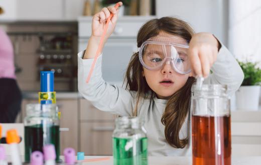 Girl playing scientist in the kitchen