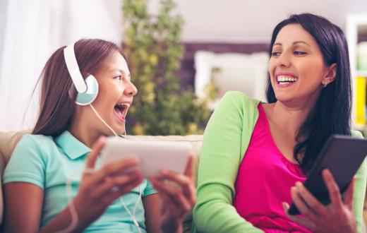 mother and teen daughter listening to a podcast