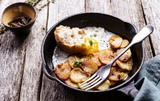 Eggs, toast and potatoes in a cast iron skillet