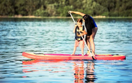 Boy and mom stand-up paddleboarding