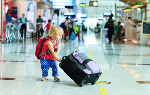 Toddler with luggage in the airport