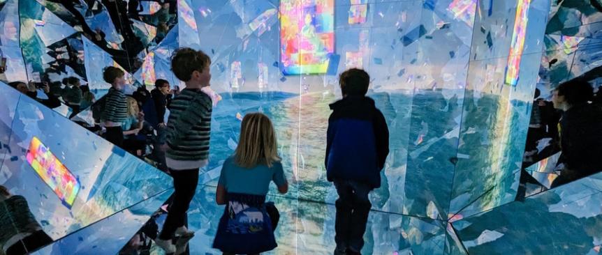 Kids interact with digital art elements at the newly opened WNDR Seattle Museum